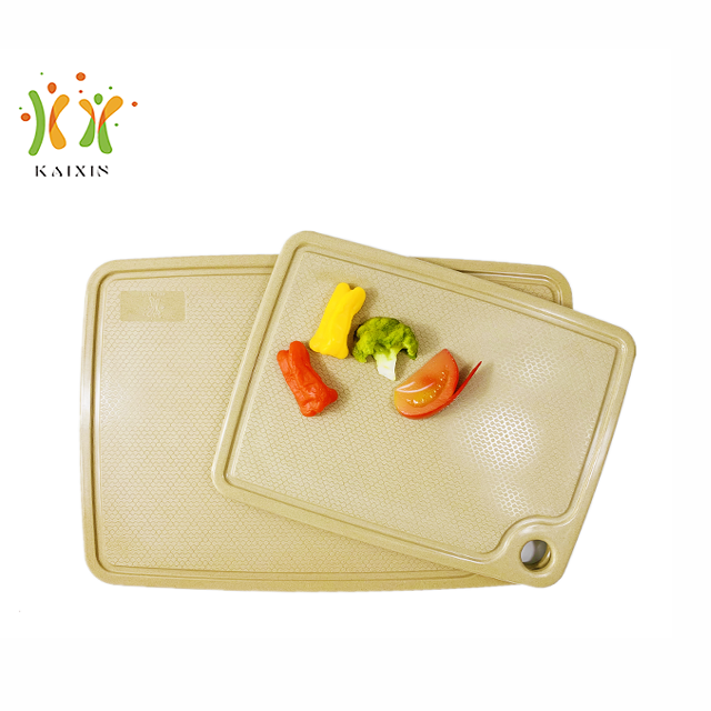 Rice husk chopping board in use with vegetables — natural, plant-based tableware